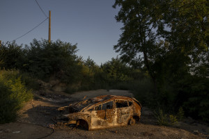 A burned car is seen close to the farmlands of Qualiano, Southern Italy on September 17, 2019. The area is part of the so-called “land of ​fires”, a site of toxic and illegal waste dump.