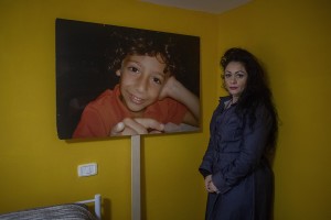 The environmental activist Marzia caccioppoli, 45 years old is portrayed next to a blow-up of his son Antonio in Casalnuovo, Southern Italy on February 26, 2021. Antonio died at the age of 9 after falling ill with glioblastoma multiforme, a disease that according to his mother would have arisen due to the environmental pollution strongly present in the land of fires.