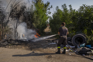 A firefighter extinguishes a fire close to the farmlands of Afragola, Southern Italy on September 17, 2019. The area is part of the so-called “land of ​fires”, a site of toxic and illegal waste dump.