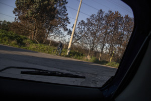 January 28, 2014 – Giugliano, Italy: An immigrant pedaling near an agricultural land where wastes are buried and from which often, during the year, emerge fumes because of leachate.