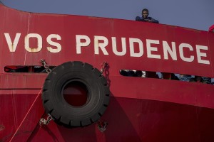 A migrant waits to disembark from the Italian rescue ship Vos Prudence run by NGO Medecins Sans Frontieres (MSF) arrived with 935 migrants on board in the port of Salerno, southern Italy on July 14, 2017.