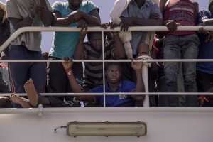 Migrants wait to disembark from the Spanish Guardia Civil Rio Segura Patrol Ship with 1216 migrants onboard including 256 children and 11 pregnant women, who were rescued in the Mediterranean sea in Salerno, Southern Italy on June 29, 2017.