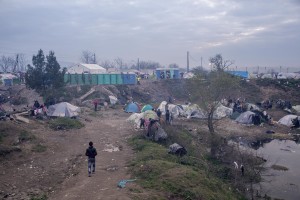 A man walks in the makeshift camp near the village of Idomeni at the Greek Macedonian border where thousands of migrants and refugees are stranded in Idomeni, Greece on March 17, 2016.