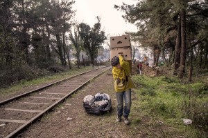 March 18, 2016 – Idomeni, Greece: A refugee child carries boxes containing firewood at the Idomeni refugee camp in Idomeni, Greece on MArch 18, 2016. Refugees’ “journey of hope” towards Western European countries where they dream of having a better life ends in the Balkans following the latest agreement between EU and Turkey.