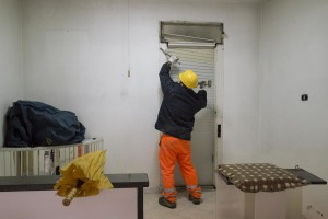 A man at work inside an apartment in the “Vele” of Scampia, during the transfer of a family into one of the new accommodations realized always in Scampia, in Naples on November 11, 2016. The “vele” of Scampia, become famous for the long and bloody Camorra feuds, will be demolished starting from spring 2017.