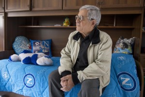 Mario Benfenati, 75, is seen inside the new accomodation of his sons after their transfer from the “vele” of Scampia, in Naples on November 25, 2016. The “vele” of Scampia, become famous for the long and bloody Camorra feuds, will be demolished starting from spring 2017.