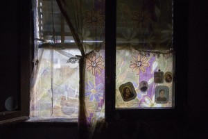 Holy images attached on the window of the apartment of Filippo Leone who is under house arrest and is waiting for the allocation of a new housing in Scampia, Naples on November 24, 2016. The “vele” of Scampia, become famous for the long and bloody Camorra feuds, will be demolished starting from spring 2017.