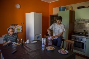 Anastas Issa, Christian from Palestine and Ali Hassan, Muslim from Pakistan and beneficiaries of the protection systems for asylum seekers and refugees, are seen in the kitchen of the house where they live in Chianche, near Petruro Irpino, southern Italy on June 14, 2017. Petruro Irpino is an Italian small village with 367 inhabitants in the province of Avellino in Campania, which is claiming to be an efficient model of integration and where people of different religions and coming from different parts in the world peaceful live together.