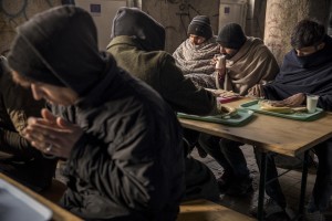 Afghans and Pakistanis migrants have a breakfast inside an abandoned building near a park in Bihać, Bosnia and Herzegovina on November 28, 2018.