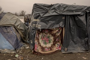 A migrant smokes a cigarette inside a refugee camp in Velika Kladusa, Bosnia and Herzegovin on November 30, 2018.
