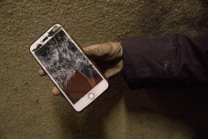 A migrant shows a mobile phones that, according to him, was destroyed by the Croatian police in Velika Kladusa, Bosnia and Herzegovina on November 30, 2018.