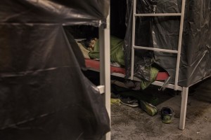 A migrant sleeps inside a reception center in Velika Kladusa, Bosnia and Herzegovina on November 30, 2018.