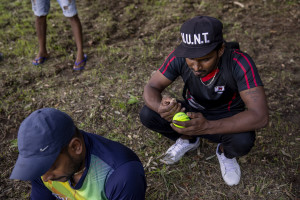 A player prepares a ball removing the fur before a match of “elle” in Naples, Italy on September 29, 2019. Every Sunday hundreds of people belonging to the Sri Lankan community in Italy gather in the “Real Bosco di Capodimonte” of Naples and play “elle”, a very popular Sri Lankan bat-and-ball game, often played in rural villages and urban areas.