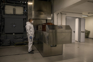 A worker dressing protective suite is seen inside the crematory in Naples, Italy on March 27, 2020. Due to the coronavirus emergency it is no longer possible to celebrate funerals inside churches and funeral processions are prohibited. In the case of cremation, relatives can greet the deceased for the last time through a monitor that shows when the coffin is introduced into the crematorium.