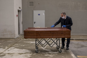 A man is seen outside “Ospedale del Mare” preparing a coffin before recovering the body of a 91 years old man died for coronavirus in Naples, Italy on March 28, 2020. The work of funeral agency officials is among those most at risk during this emergency, as often can find in contact with corpses of people who died by coronavirus and the risk of contagion is very high.