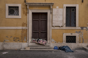 Homeless are seen in Piazza dei Crociferi during the Coronavirus emergency in Rome, Italy on March 30, 2020. Homeless are experiencing a double emergency: the first one due to their condition, the second one linked to the spread of the coronavirus that caused the closure of many assistance centers because of possible contagion.