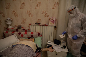 A nurse of the Italian Red Cross checks Lesya’s pressure after an emergency call received in the night, for suspected coronavirus symptoms in Naples, Italy on April 7, 2020.