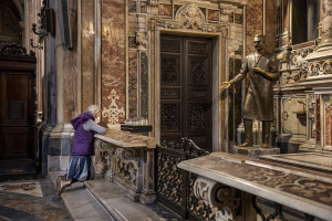 A woman wearing a mask prays in front of the Saint Giuseppe Moscati statue inside the “Gesù Nuovo” church on the third day of unprecedented lockdown across of all Italy imposed to slow the spread of coronavirus in Naples, Southern Italy on March 12, 2020.