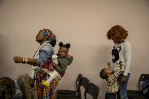 People pray during the Sunday mass celebrated by Princess Inyang Okokon inside a Pentecostal church in Asti, Northern Italy on January 12, 2020.