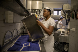 Vivian, 23 years old from Delta State, Nigeria is seen at work inside the kitchen of the Bar Carducci where she carries out her internship in Asti, Northern Italy on January 9, 2020. Vivian has been in Italy for 3 years and settled in Asti since two. Like Vivian, other girls rescued from the street have obtained asylum seeker status and have joined the SPRAR project (protection system for asylum seekers and refugees).