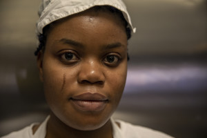 A portrait of Vivian, 23 years old from Delta State, Nigeria inside the kitchen of the Bar Carducci where she carries out her internship in Asti, Northern Italy on January 9, 2020. Vivian has been in Italy for 3 years and settled in Asti since two. Like Vivian, other girls rescued from the street have obtained asylum seeker status and have joined the SPRAR project (protection system for asylum seekers and refugees).