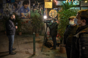 A foreign TV crew at work in the Spanish Quarter after the announcement of the Argentine soccer legend Diego Armando Maradona death, in Naples, Italy on November 27, 2020.