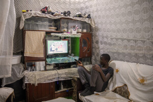 Dance Centre Kenya student Bravian Mise, 14 years old watches television inside his home at the Kuwinda slum in Nairobi, Kenya on October 10, 2024. The main purposes of Dance Centre Kenya is to provide international training for talented young dancers, regardless of their background or nationality. It also represents a bridge between Africa and foreign countries, giving dozens of less fortunate children the chance to dream of a better future.