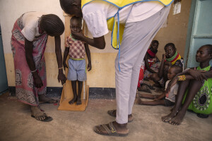 Kennedy Ekalimon, manager of “Nutrition Program” measures the height of a child at the Chok Chok dispensary, located in Turkana County, northwest Kenya on October 14, 2024. The Chok Chok dispensary was founded in 2016 by the Turkana Country Government and thanks to the “Nutrition Program” once a week it welcomes women and children from the surrounding villages to provide them with medicines, food supplements and to monitor their health conditions, which are put at risk by the severe drought that is affecting the country.