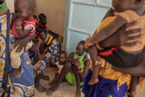 Women and children wait their turn at the Chok Chok dispensary, located in Turkana County, northwest Kenya on October 14, 2024. The Chok Chok dispensary was founded in 2016 by the Turkana Country Government and thanks to the “Nutrition Program” once a week it welcomes women and children from the surrounding villages to provide them with medicines, food supplements and to monitor their health conditions, which are put at risk by the severe drought that is affecting the country.