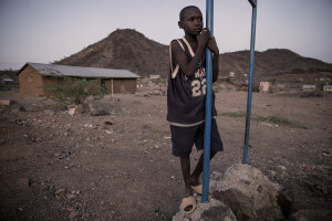 A child stands near the bank of the dried Kawalasee River in Lodwar, northwest Kenya on October 19, 2024. Kenya’s rivers are drying up rapidly, with low rainfall and global warming being among the main causes of this phenomenon.