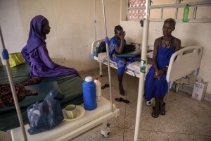 Anki, 27 years old (center) is seen desperate with her one-day-old son Dilan, while her mother Rebecca, 44 years old (right) and her nun friend Veronica, 50 years old (left) stand by her at Kangatosa Health Centre located in Turkana County, northwest Kenya on October 19, 2024. Due to the severe drought that is affecting the country, Anki and her family, including her newborn son, are forced to drink water that they fetch from the underground, which is not clean and often causes infections or diseases, including dysentery, a leading cause of death among children under 5.