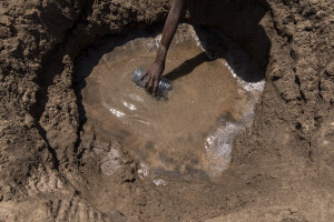 A child fetches water from the dried Turkwel River in Chok Chok village, located in Turkana County, northwest Kenya on October 14, 2024. Due to the severe drought that is affecting the country, many people are forced to drink water that they fetch from the underground, which is not clean and often causes infections or diseases, including dysentery, a leading cause of death among children under 5.