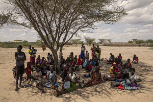 Women and children wait their turn outside the Kalokol Gok Health Centre, located in Turkana County, northwest Kenya on October 16, 2024. The Kalokol Gok Health Centr welcomes women and children from the surrounding villages to provide them with medicines, food supplements and to monitor their health conditions, which are put at risk by the severe drought that is affecting the country.