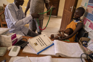 Doctors use a device to measure the heart rate of Quinta, 4 months old while her mother Nancy, 32 years old holds her inside the examination room of the Kangatosa Health Centre located in Turkana County, northwest Kenya on October 19, 2024. Kangatosa Health Centre welcomes women and children from the surrounding villages to provide them with medicines, food supplements and to monitor their health conditions, which are put at risk by the severe drought that is affecting the country.